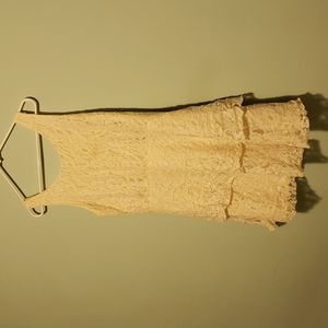 Cute lacy cream dress. 2 Ruffled layers Zipper in back. Good condition